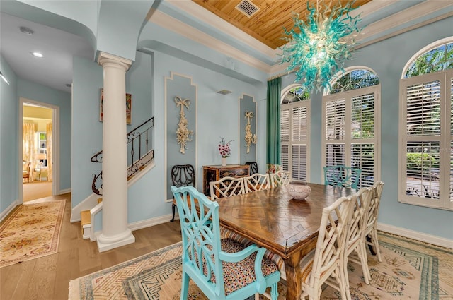 dining area with decorative columns, wood finished floors, baseboards, recessed lighting, and stairs