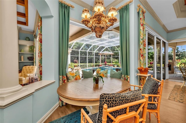 sunroom / solarium featuring a chandelier