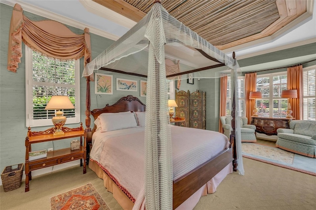 bedroom featuring crown molding, carpet floors, and a tray ceiling