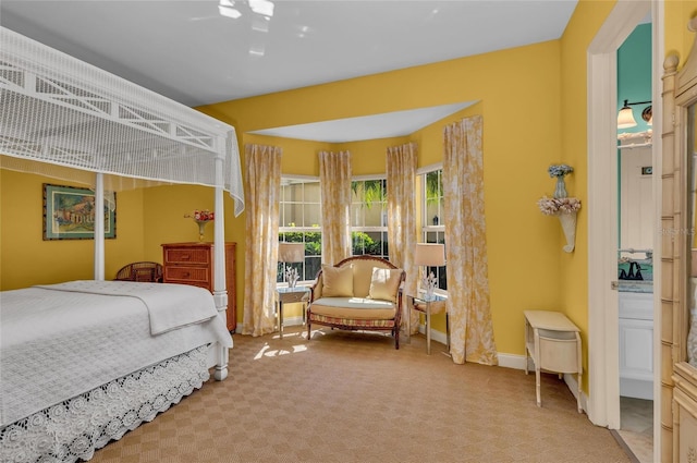 bedroom featuring light colored carpet and baseboards