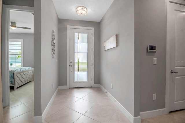 10414 Spring Tide Way, Parrish, FL 34219 - doorway featuring a ceiling fan, baseboards, and light tile patterned flooring