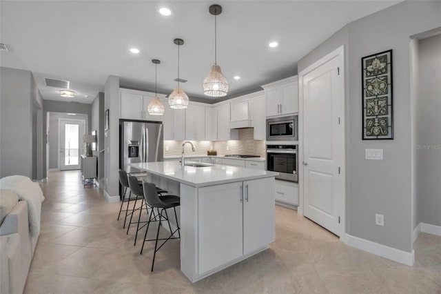 10414 Spring Tide Way, Parrish, FL 34219 - kitchen with stainless steel appliances, a sink, decorative backsplash, a breakfast bar area, and baseboards