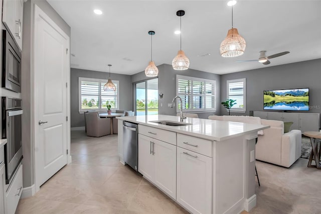 10414 Spring Tide Way, Parrish, FL 34219 - kitchen with a sink, open floor plan, stainless steel appliances, light countertops, and a center island with sink