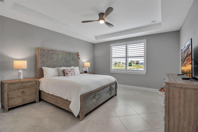 10414 Spring Tide Way, Parrish, FL 34219 - bedroom with a tray ceiling, light tile patterned floors, baseboards, and ceiling fan