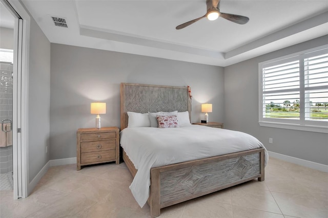 10414 Spring Tide Way, Parrish, FL 34219 - bedroom featuring a tray ceiling, baseboards, light tile patterned floors, and ceiling fan