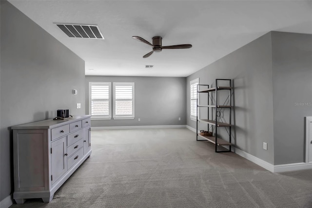 10414 Spring Tide Way, Parrish, FL 34219 - empty room with ceiling fan, light colored carpet, healthy amount of natural light, and baseboards