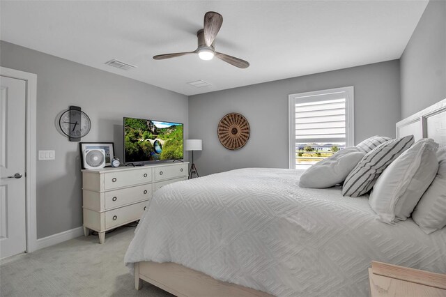 10414 Spring Tide Way, Parrish, FL 34219 - bedroom with light colored carpet, a ceiling fan, and baseboards