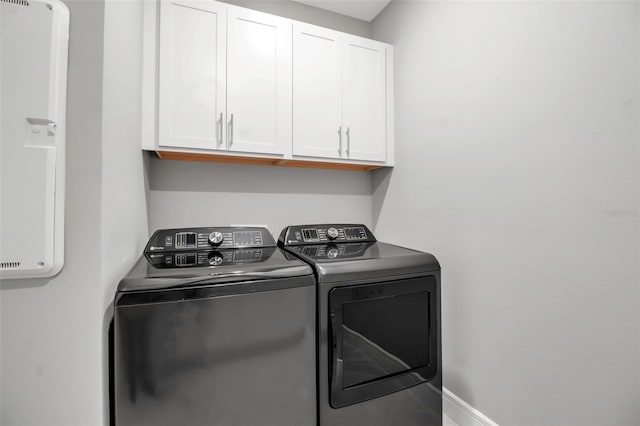 10414 Spring Tide Way, Parrish, FL 34219 - clothes washing area with separate washer and dryer and cabinet space