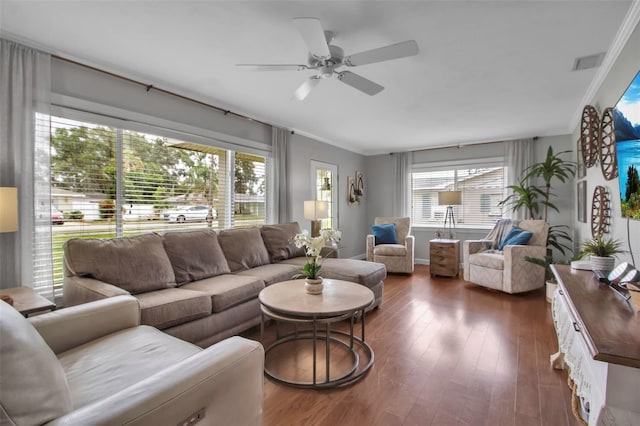 living area featuring crown molding, a ceiling fan, and wood finished floors