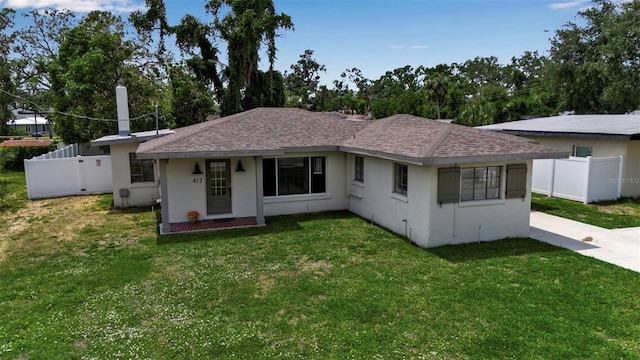 view of front facade featuring stucco siding and roof with shingles
