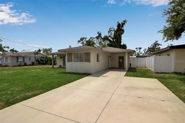 view of front of property featuring concrete driveway, stucco siding, central AC, and an attached carport