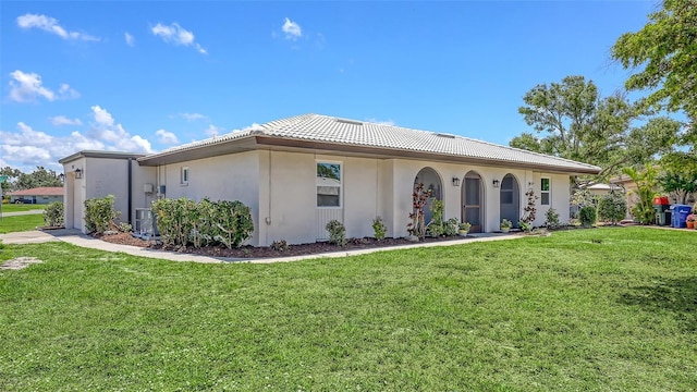 445 Matisse Cir S Unit 445, Nokomis, FL 34275 - view of front of property with a front lawn, stucco siding, a tile roof, and cooling unit