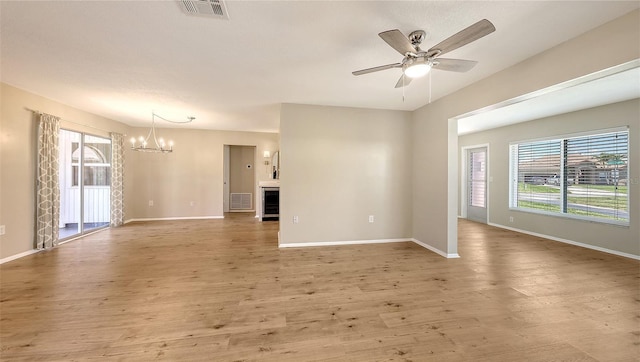 445 Matisse Cir S Unit 445, Nokomis, FL 34275 - empty room featuring a chandelier, baseboards, wood finished floors, and a ceiling fan