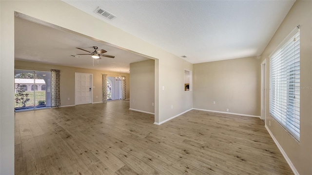 445 Matisse Cir S Unit 445, Nokomis, FL 34275 - spare room with a chandelier, wood finished floors, baseboards, and a ceiling fan