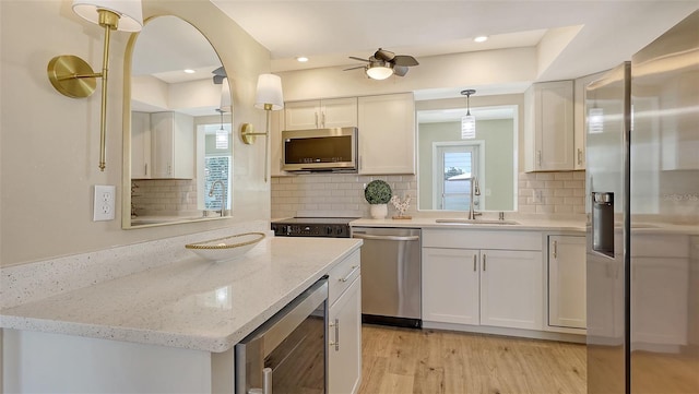 445 Matisse Cir S Unit 445, Nokomis, FL 34275 - kitchen featuring stainless steel appliances, wine cooler, a sink, white cabinetry, and a ceiling fan