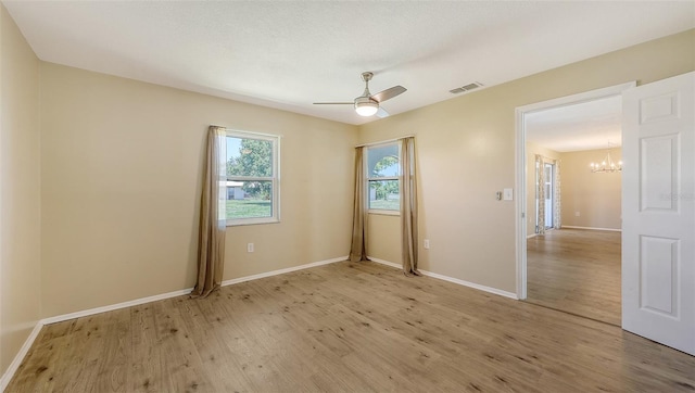 445 Matisse Cir S Unit 445, Nokomis, FL 34275 - unfurnished bedroom featuring a chandelier, light wood-style flooring, baseboards, and ceiling fan