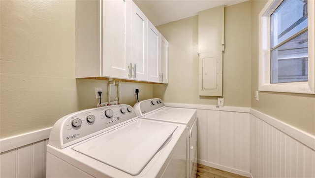 445 Matisse Cir S Unit 445, Nokomis, FL 34275 - laundry room featuring washer and dryer, wainscoting, and cabinet space