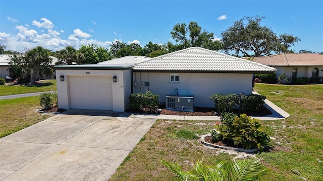445 Matisse Cir S Unit 445, Nokomis, FL 34275 - view of front facade featuring a garage, a front lawn, concrete driveway, and a tile roof