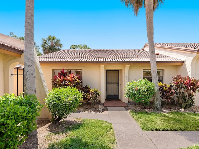 view of front of property with a tile roof and stucco siding