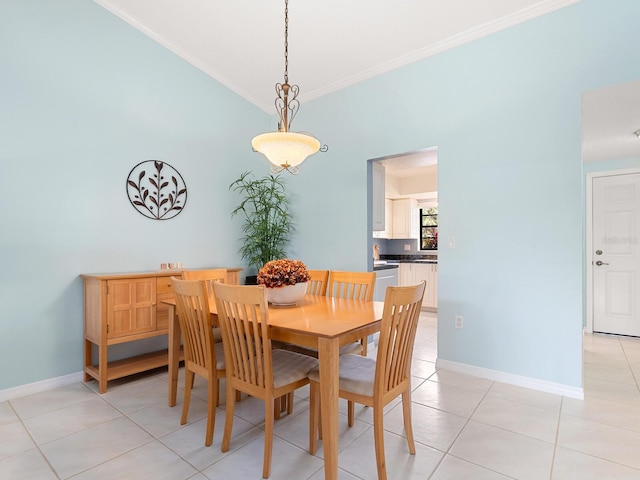 dining area featuring crown molding, light tile patterned floors, and baseboards