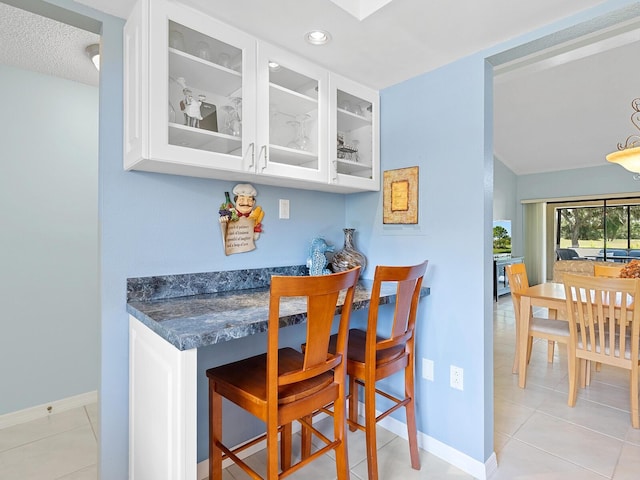 bar featuring light tile patterned flooring, baseboards, and recessed lighting