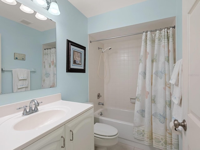 bathroom featuring shower / bath combo with shower curtain, vanity, and toilet