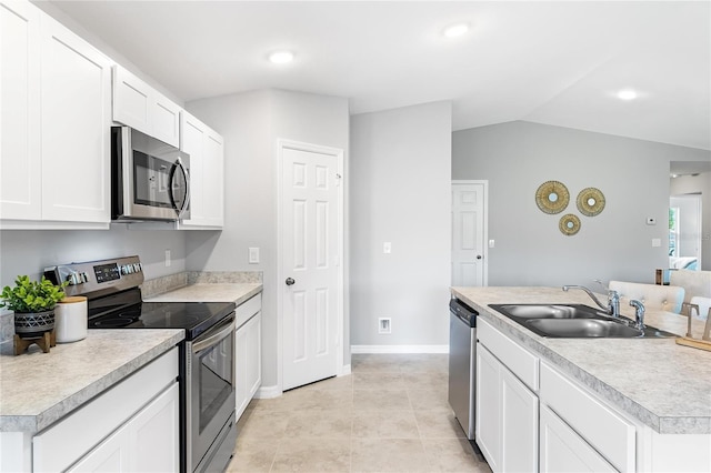 1446 Appaloosa St, Port Charlotte, FL 33980 - kitchen with stainless steel appliances, a sink, light countertops, vaulted ceiling, and white cabinets