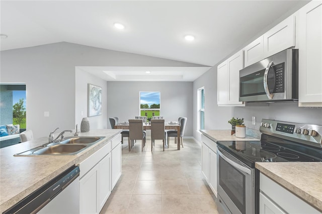 1446 Appaloosa St, Port Charlotte, FL 33980 - kitchen featuring stainless steel appliances, a sink, lofted ceiling, white cabinetry, and light tile patterned flooring