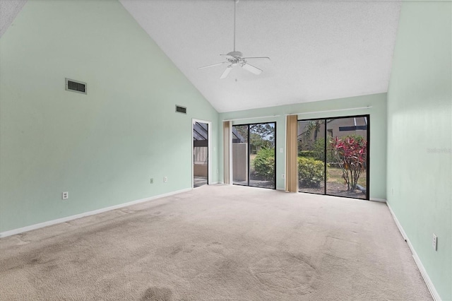 carpeted spare room featuring high vaulted ceiling, a ceiling fan, and baseboards
