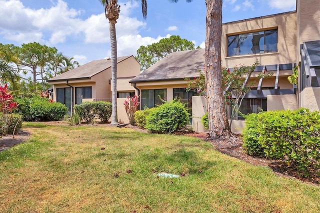 view of front of home with a front lawn and stucco siding