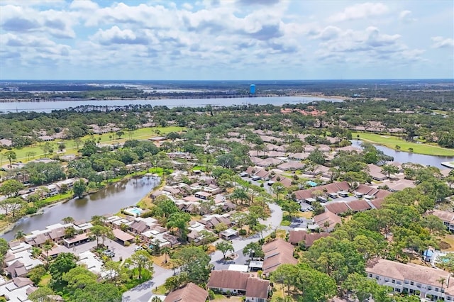 aerial view of residential area featuring a large body of water