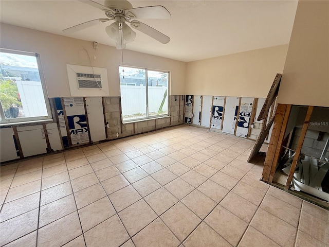 1726 8th St, Sarasota, FL 34236 - empty room featuring healthy amount of natural light, light tile patterned flooring, a ceiling fan, and a wall unit AC