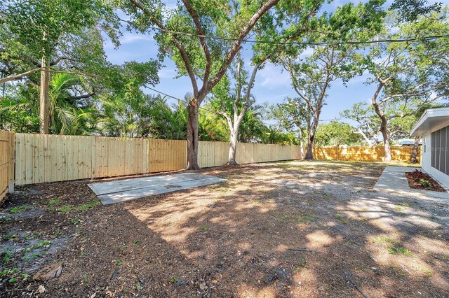 fenced backyard with a patio area