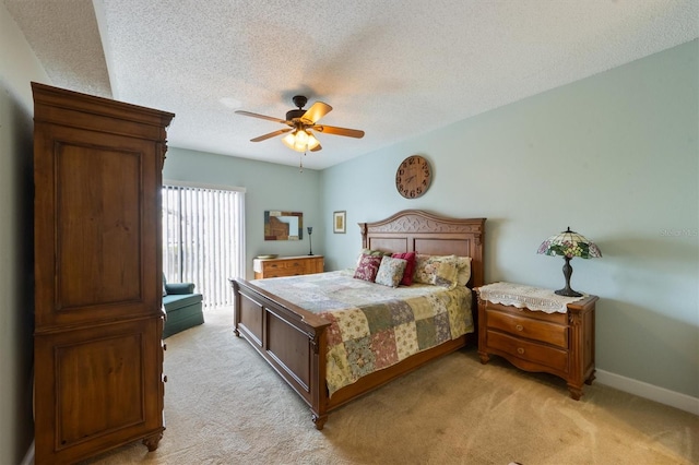 bedroom with light colored carpet, a textured ceiling, baseboards, and ceiling fan