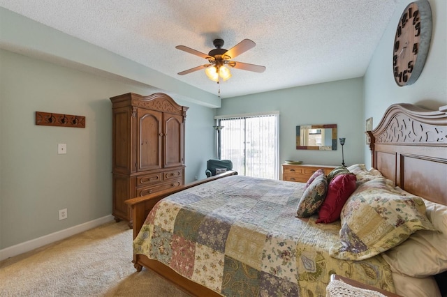 bedroom featuring light carpet, a textured ceiling, baseboards, and ceiling fan