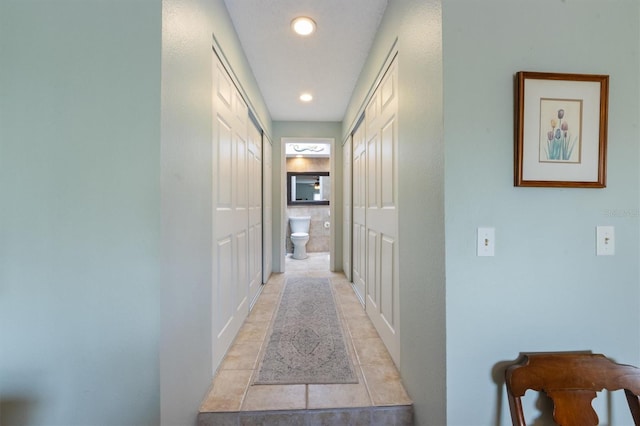 corridor featuring recessed lighting and light tile patterned floors