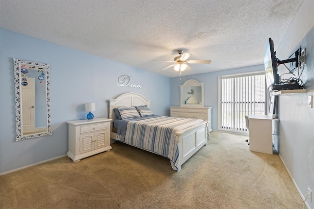 bedroom with light carpet, a textured ceiling, a ceiling fan, and baseboards