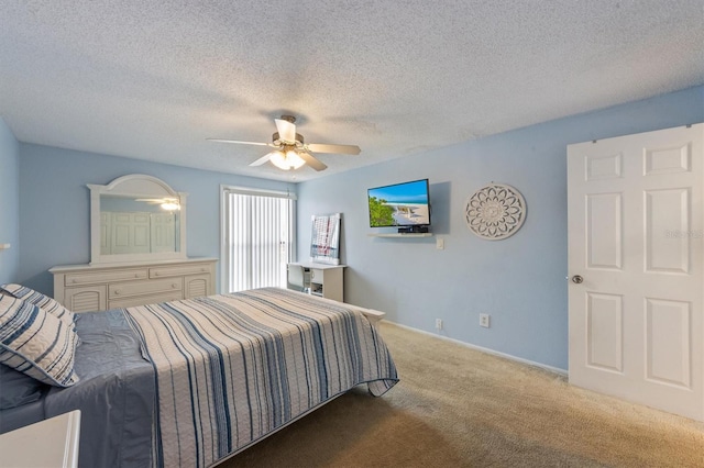 bedroom with carpet, a textured ceiling, a ceiling fan, and baseboards