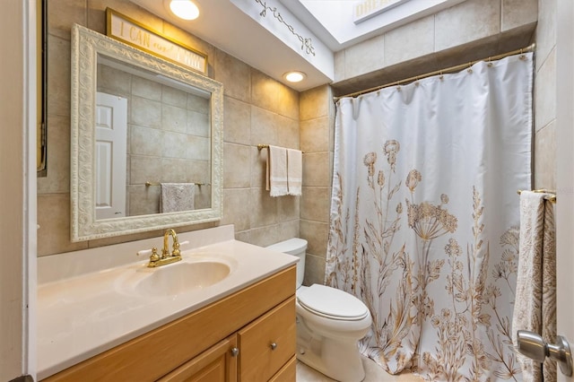 full bathroom with toilet, tile walls, vanity, and a shower with curtain