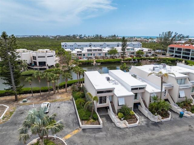 aerial perspective of suburban area with a large body of water