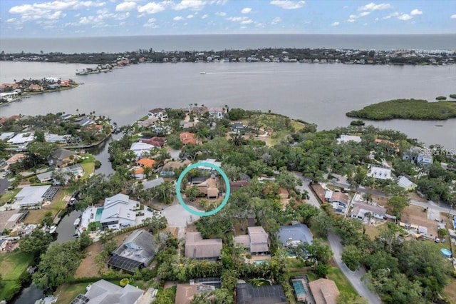 aerial view of residential area featuring a large body of water