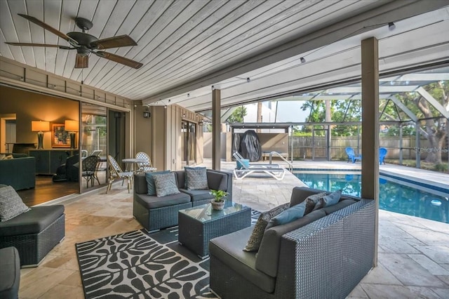 view of swimming pool featuring an outdoor living space, a patio area, a fenced backyard, a ceiling fan, and a lanai
