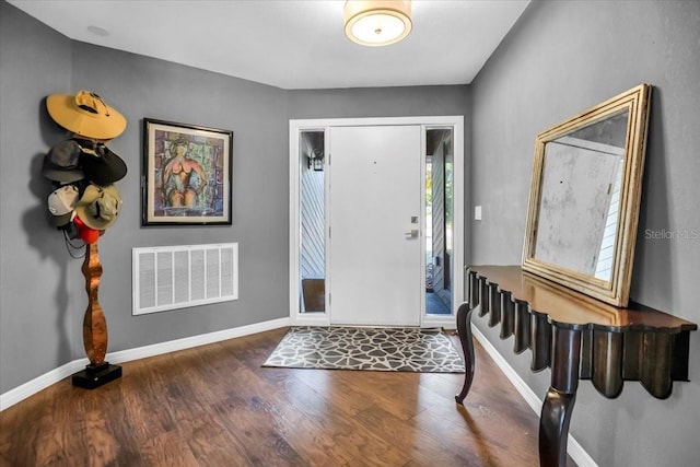 foyer with wood finished floors and baseboards