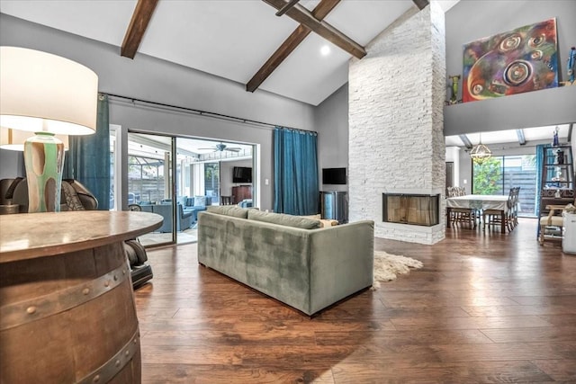 1809 Buccaneer Ter, Sarasota, FL 34231 - living room featuring beam ceiling, plenty of natural light, hardwood / wood-style flooring, high vaulted ceiling, and a fireplace
