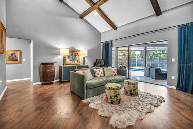 living area with high vaulted ceiling, baseboards, beam ceiling, and wood finished floors