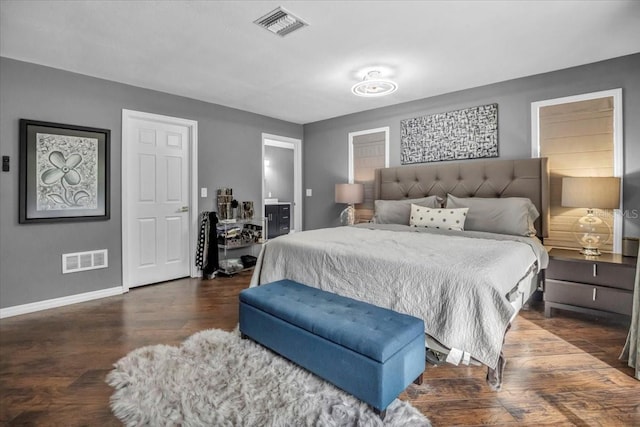 bedroom with wood finished floors and baseboards
