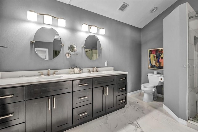 full bathroom featuring baseboards, marble look tile flooring, toilet, a shower with shower door, and double vanity