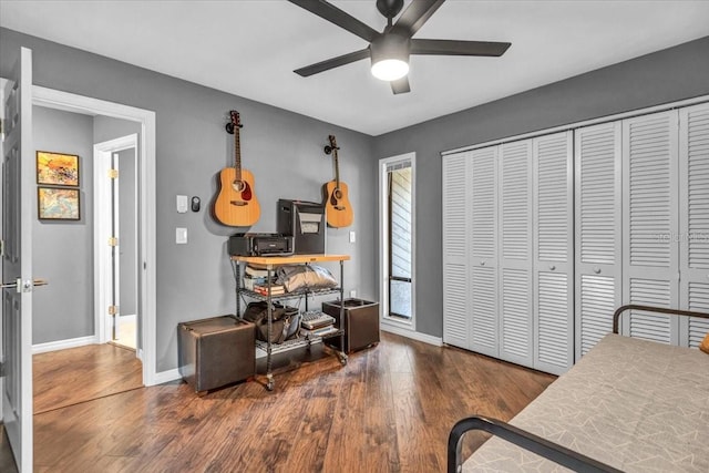 office featuring a ceiling fan, wood finished floors, and baseboards