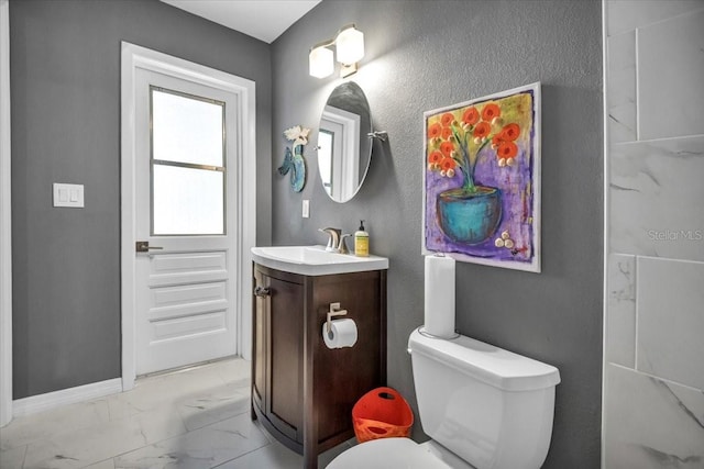 1809 Buccaneer Ter, Sarasota, FL 34231 - bathroom featuring marble finish floors, vanity, toilet, baseboards, and a textured wall