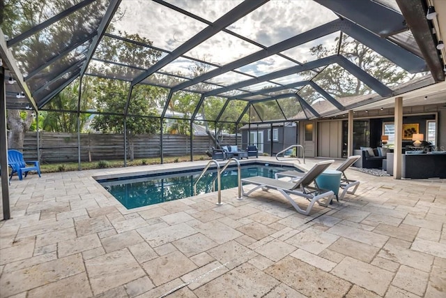 view of pool with a patio, a lanai, and a fenced backyard